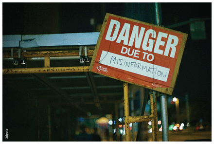 Sign on scaffolding that reads "Danger due to misinformation".