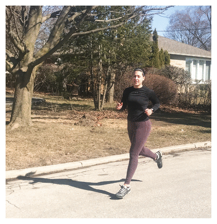 Photo of Lia Mattacchione outdoors jogging on a residential street.