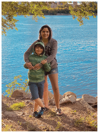 Diana Pineda and her son standing on a river bank.